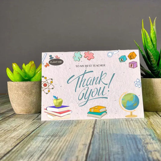 Seed paper thank you card with To my best teacher, thank you! surrounded by atoms, books, and puzzle pieces. Wordkind.