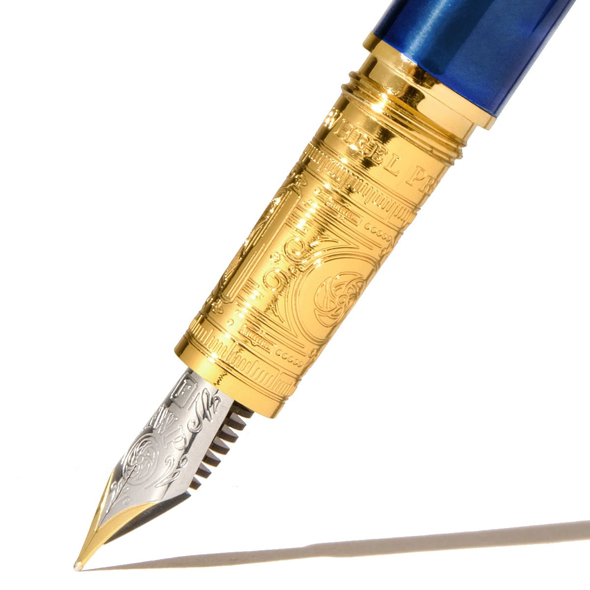 Close-up of a finely engraved gold and silver fountain pen nib. Wordkind.