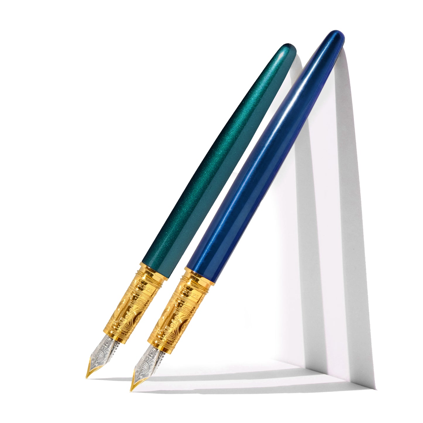 One teal and one sapphire blue fountain pen. Wordkind.