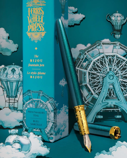 Ferris Wheel Press Bijou fountain pen in Printmaker's Teal with a carnival-themed background, Wordkind