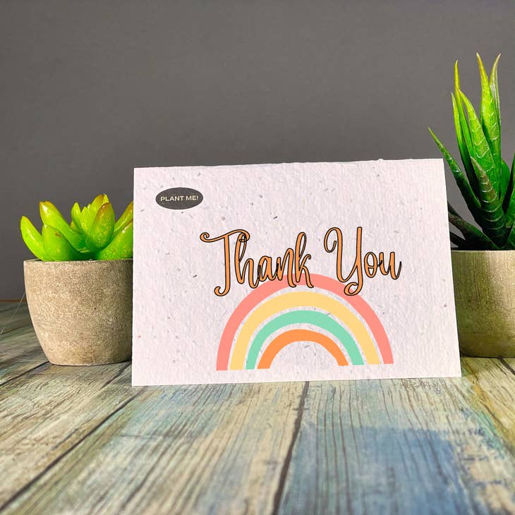 Seed paper thank you card with a multicoloured rainbow  and thank you written over top. Wordkind.